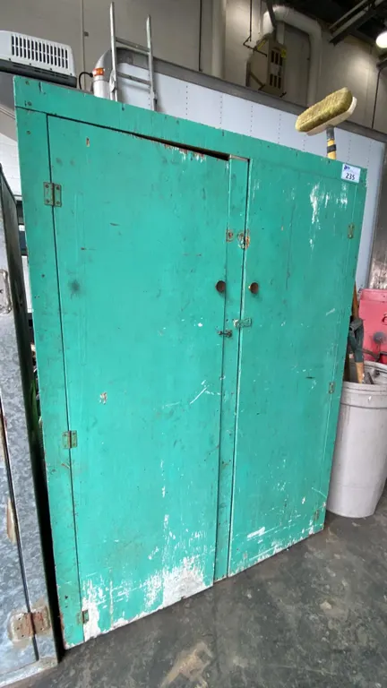 GREEN WOODEN STORAGE CABINET WITH ASSORTED MOSTLY AUTOMOTIVE CONTENTS INCLUDING WIRE, SPARK PLUGS,