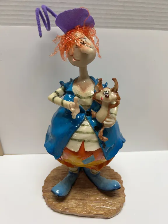 Colorful Ceramic Figurine with Purple Hat and Animal Companion