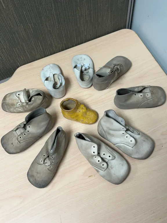 Eight Leather and Plaster Baby Shoes