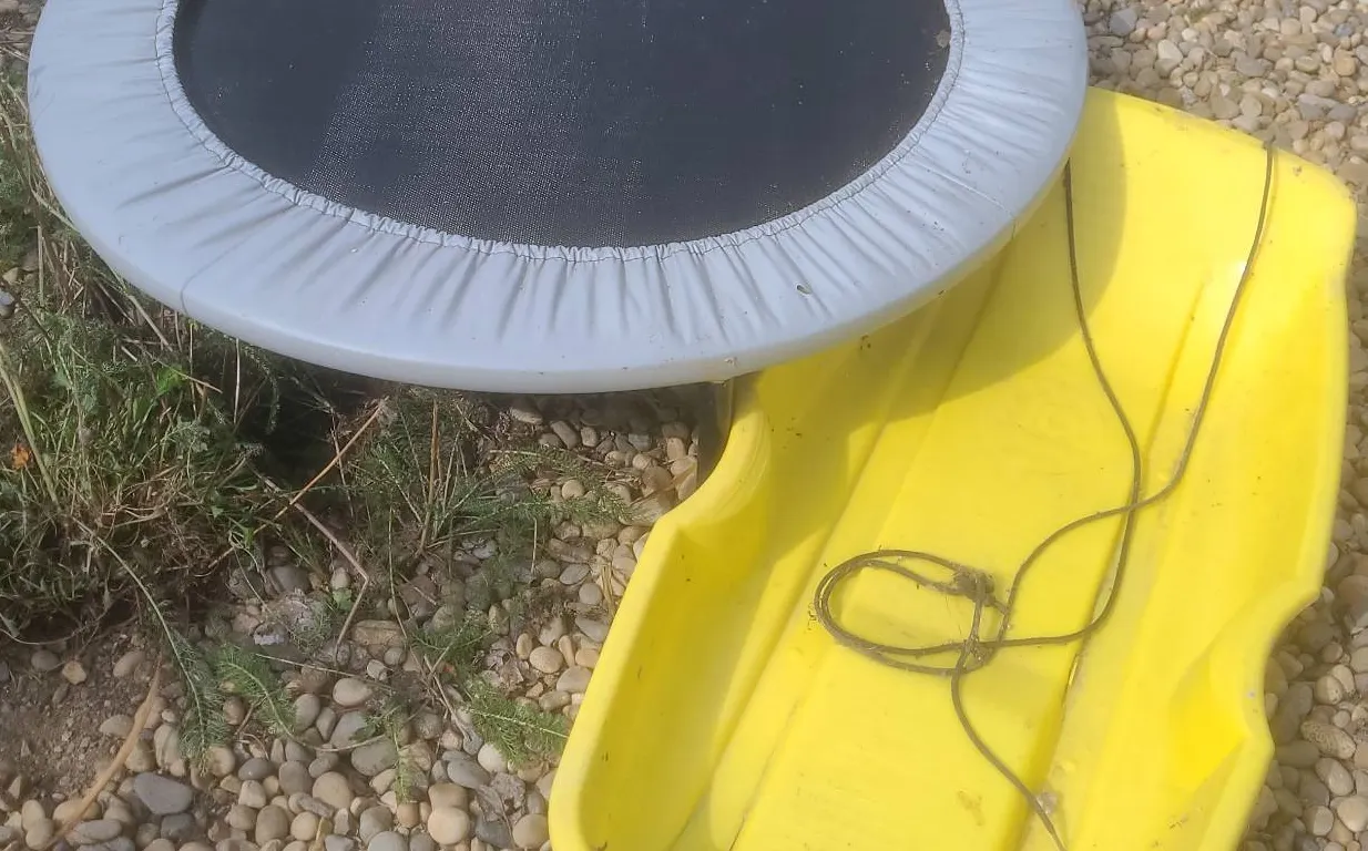 Mini Trampoline with Padded Edge and Yellow Plastic Snow Sled