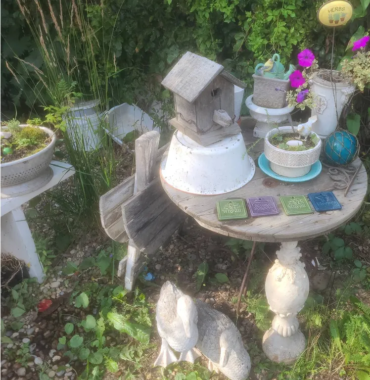 Rustic Garden Decor With Wire Spool Table, Birdhouse, and Duck Statues