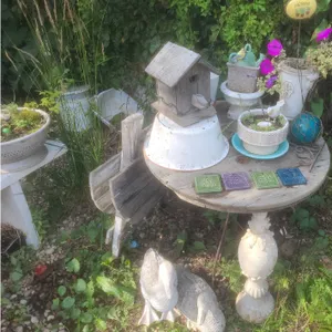 Rustic Garden Decor With Wire Spool Table, Birdhouse, and Duck Statues