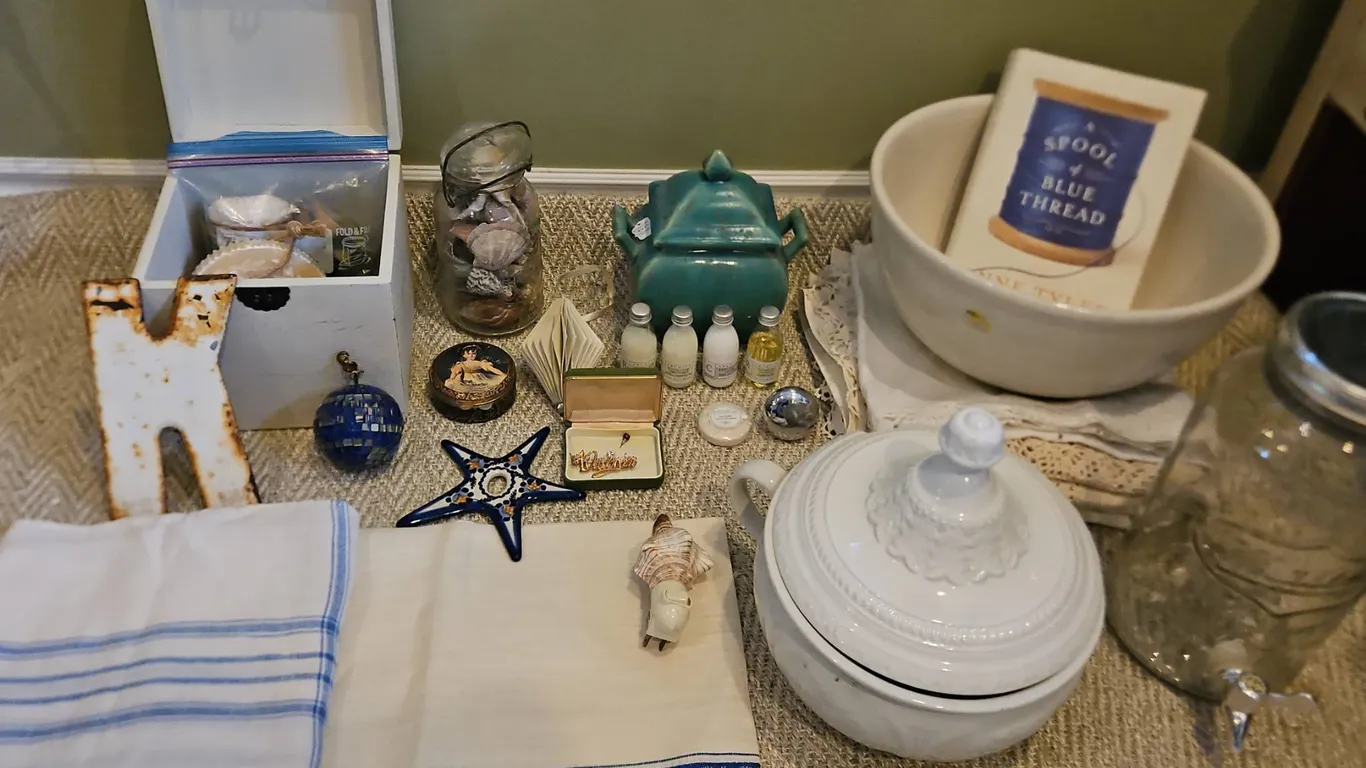 Household Items Including Glass Mason Jar, Ceramic Bowl, Linens, Toiletries, and Decorative Pieces