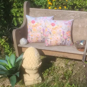 Wooden Church Pew Bench with Pillows, Metal Rake, and Garden Decor