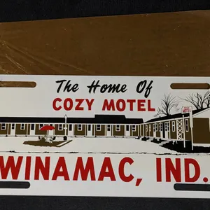 NOS TIN LICENSE PLATE TOPPER SIGN THE HOME OF COZY MOTEL WINIMAC IND IN INDIANA