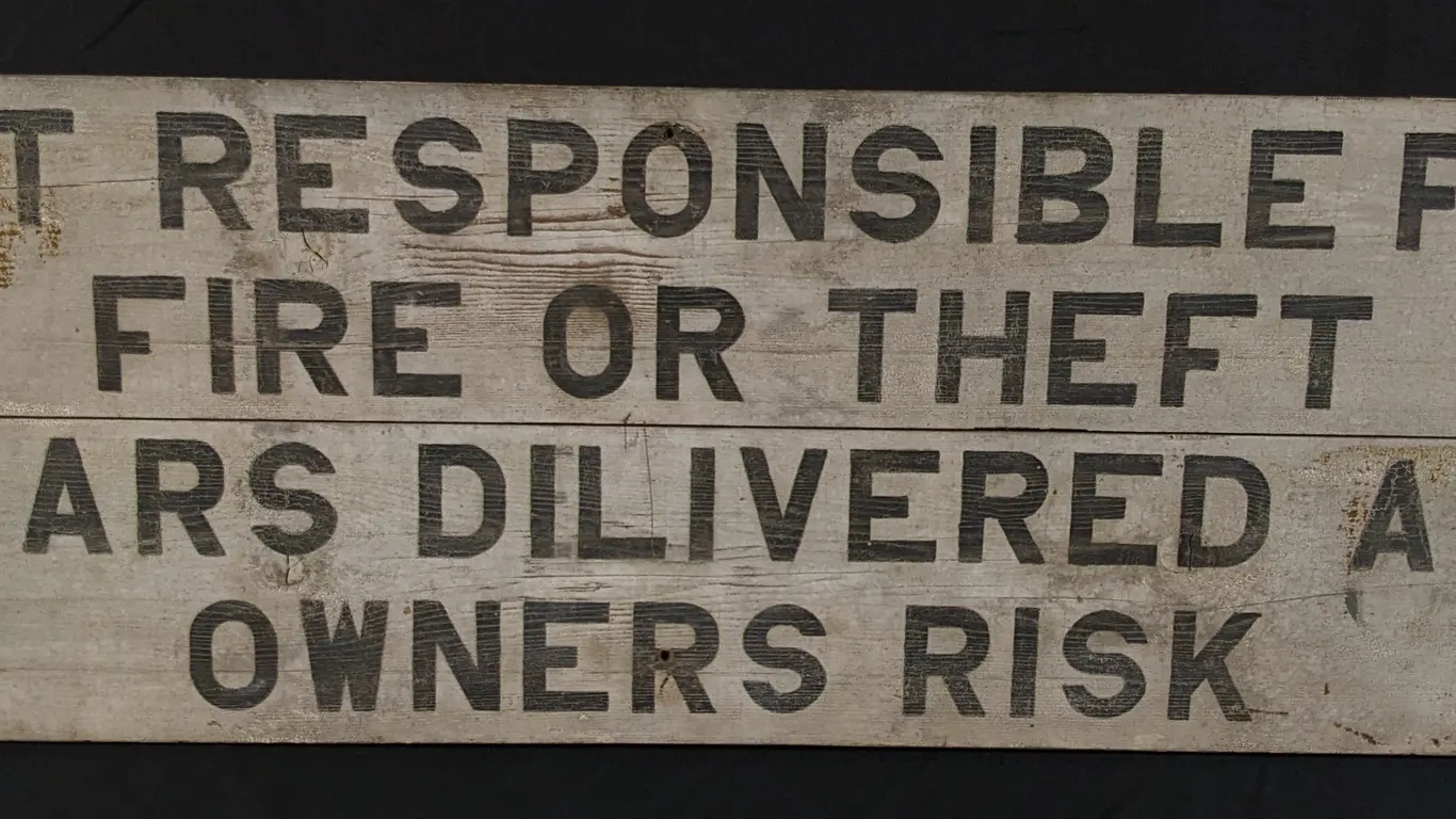 WOOD SIGN NOT RESPONSIBLE FOR FIRE OR THEFT CARS DELIVERED AT OWNERS RISK
