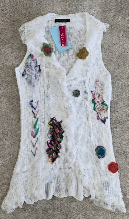 Sixe XL Bohemian open-knit vest features a whimsical patchwork design with floral fabric scraps, cro
