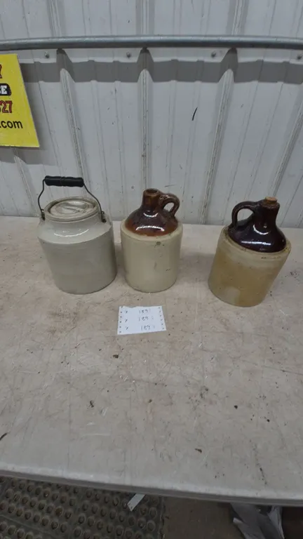 Three Stoneware Jugs: 1 with Wire and Wood Bail Handle, 2 Brown Glaze Tops, and 1 with Cork