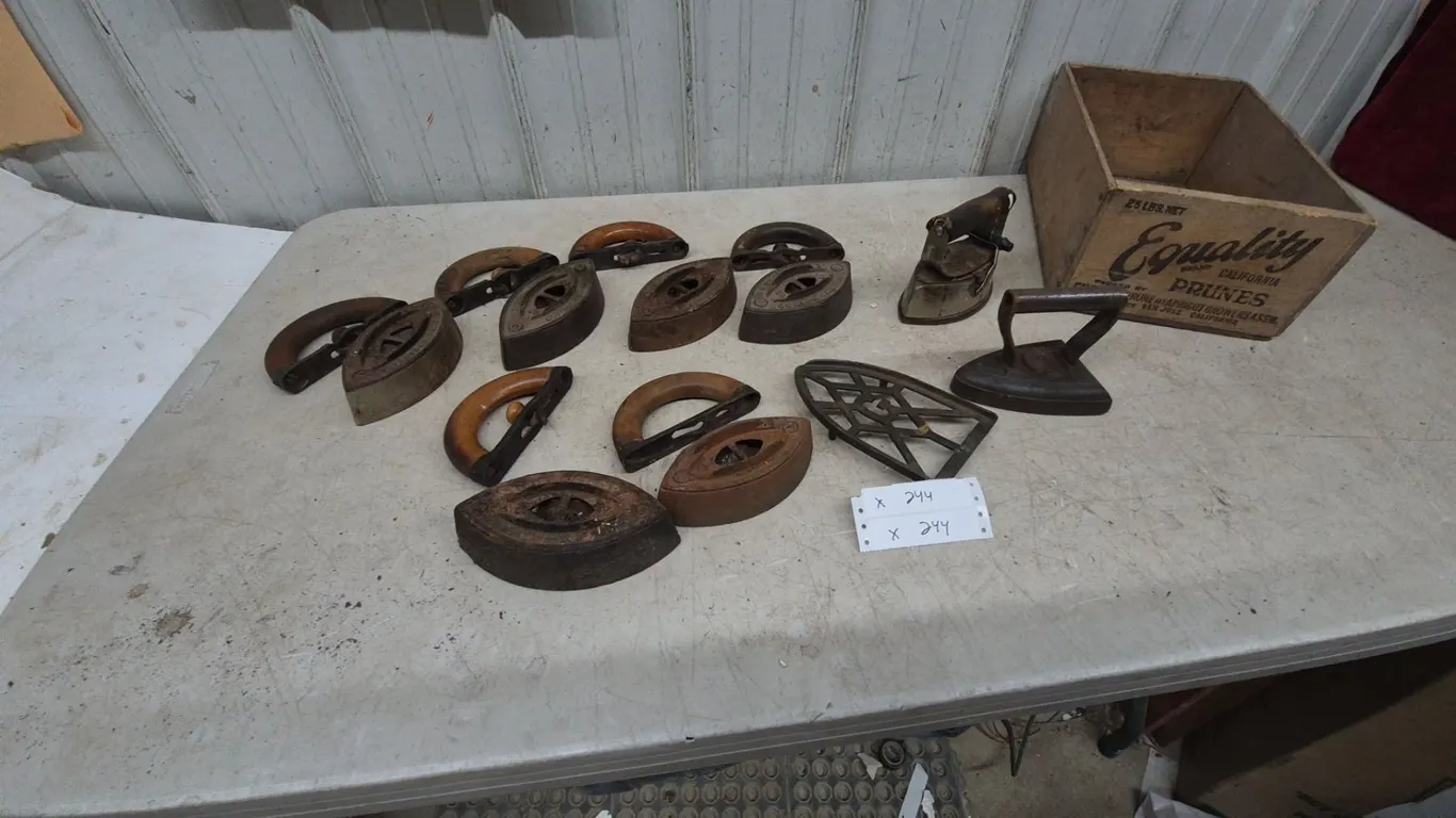 Collection of Antique Sad Irons, Trivets, and Equality Prune crate