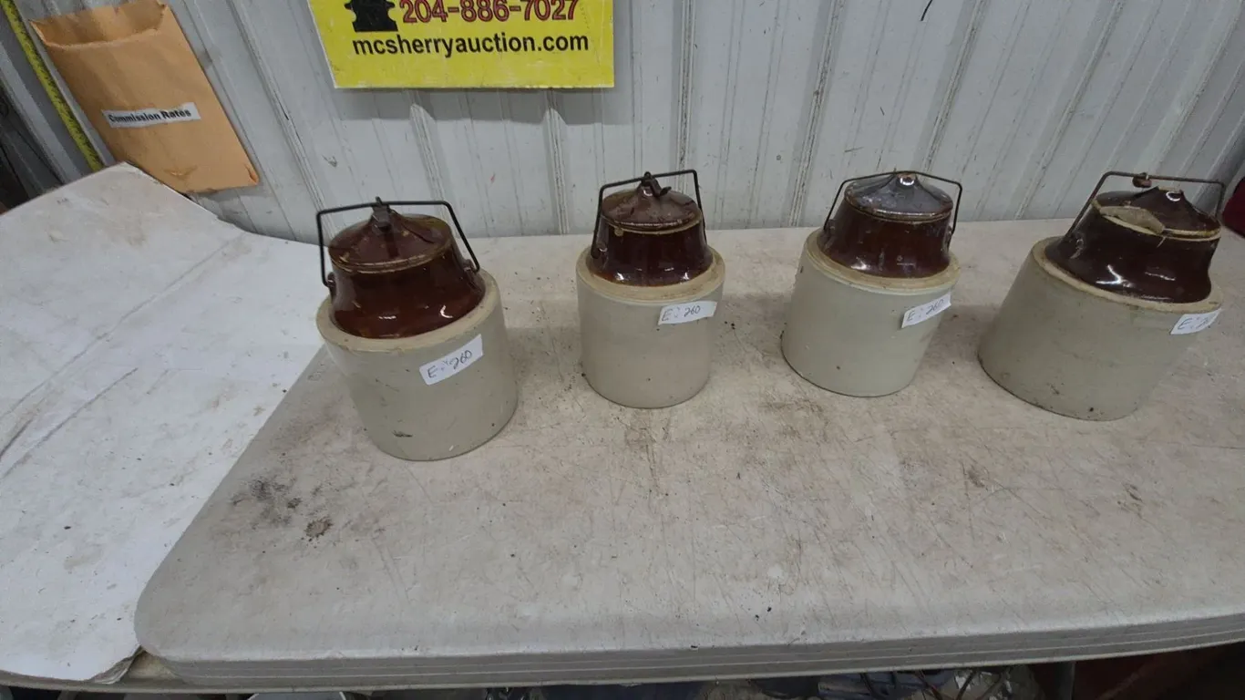 Four Stoneware Crocks with Brown Glazed Lids and Wire Bails