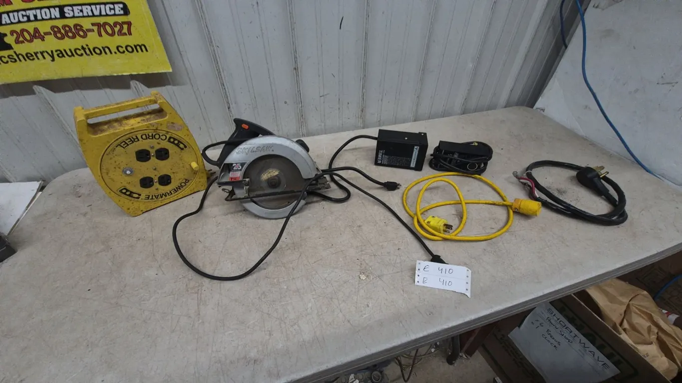 Skilsaw 7-1/4” Circular Saw, Powermate Cord Reel, and Assorted Power Cords and Timers