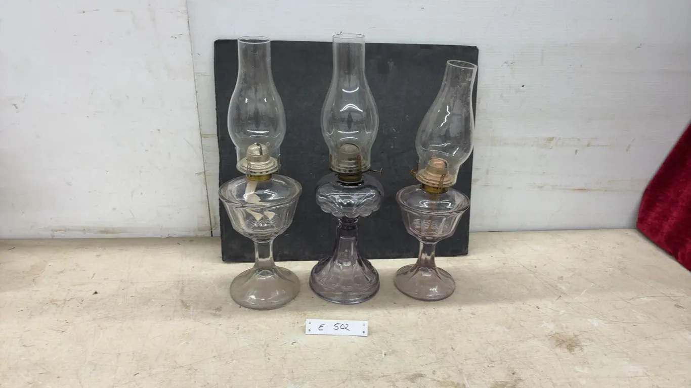 Three Vintage Sun-Purpled Pressed Glass Kerosene Oil Lamps With Chimneys and Brass Burners