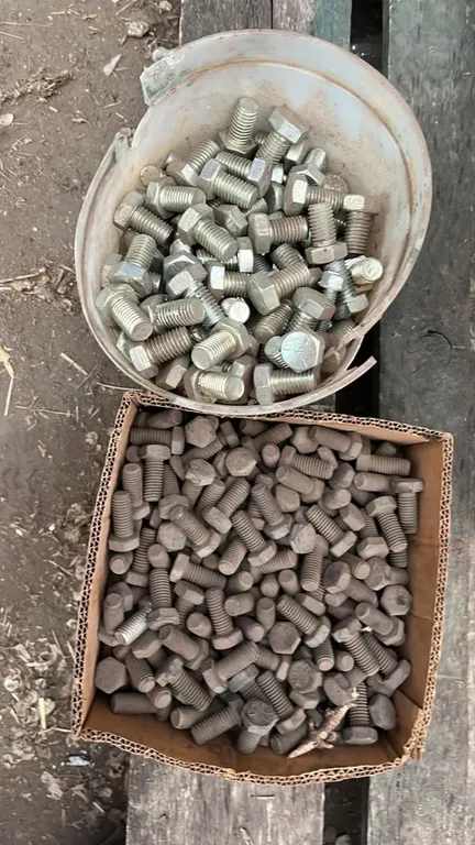 OFFSITE - Box of 7/16”c 1 1/8” bolts and pail of 5/8”x1” bolts.