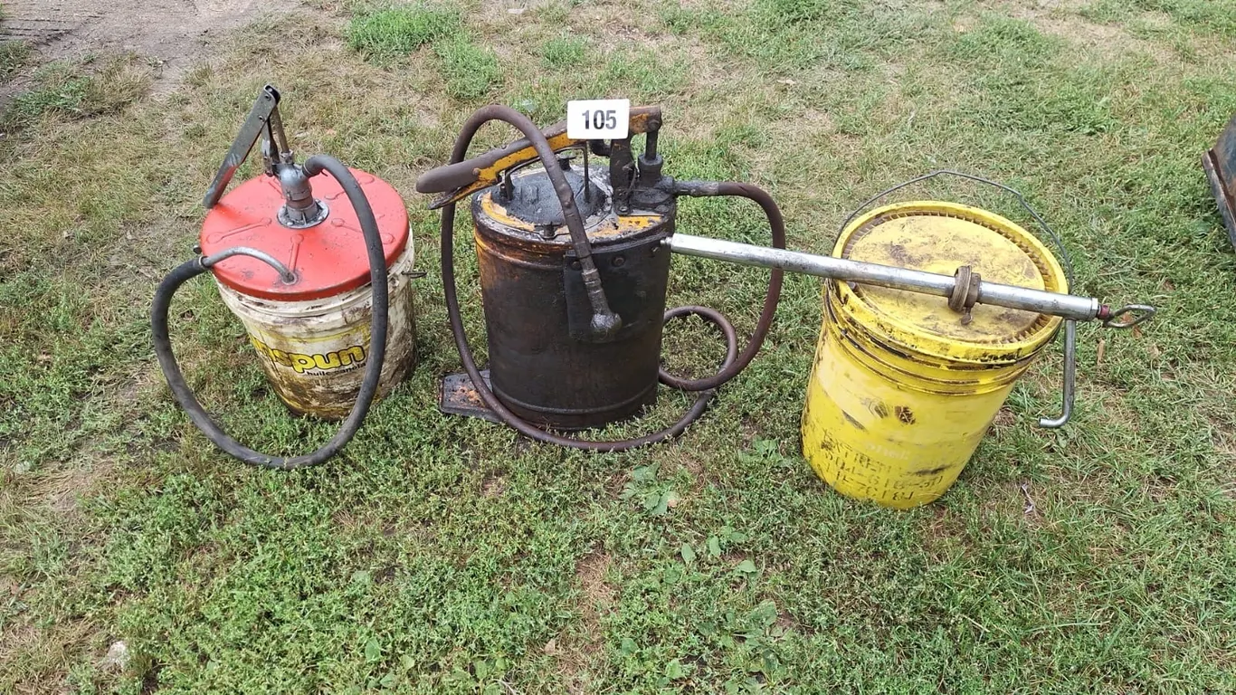 Cat greese gun with greeses. Oil bucket with pump. Barrel pump and half bucket of grees