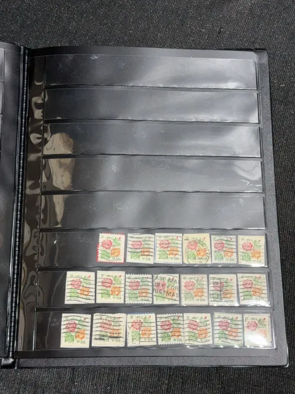 Album With 563 Used United States Commemorative and Definitive Stamps