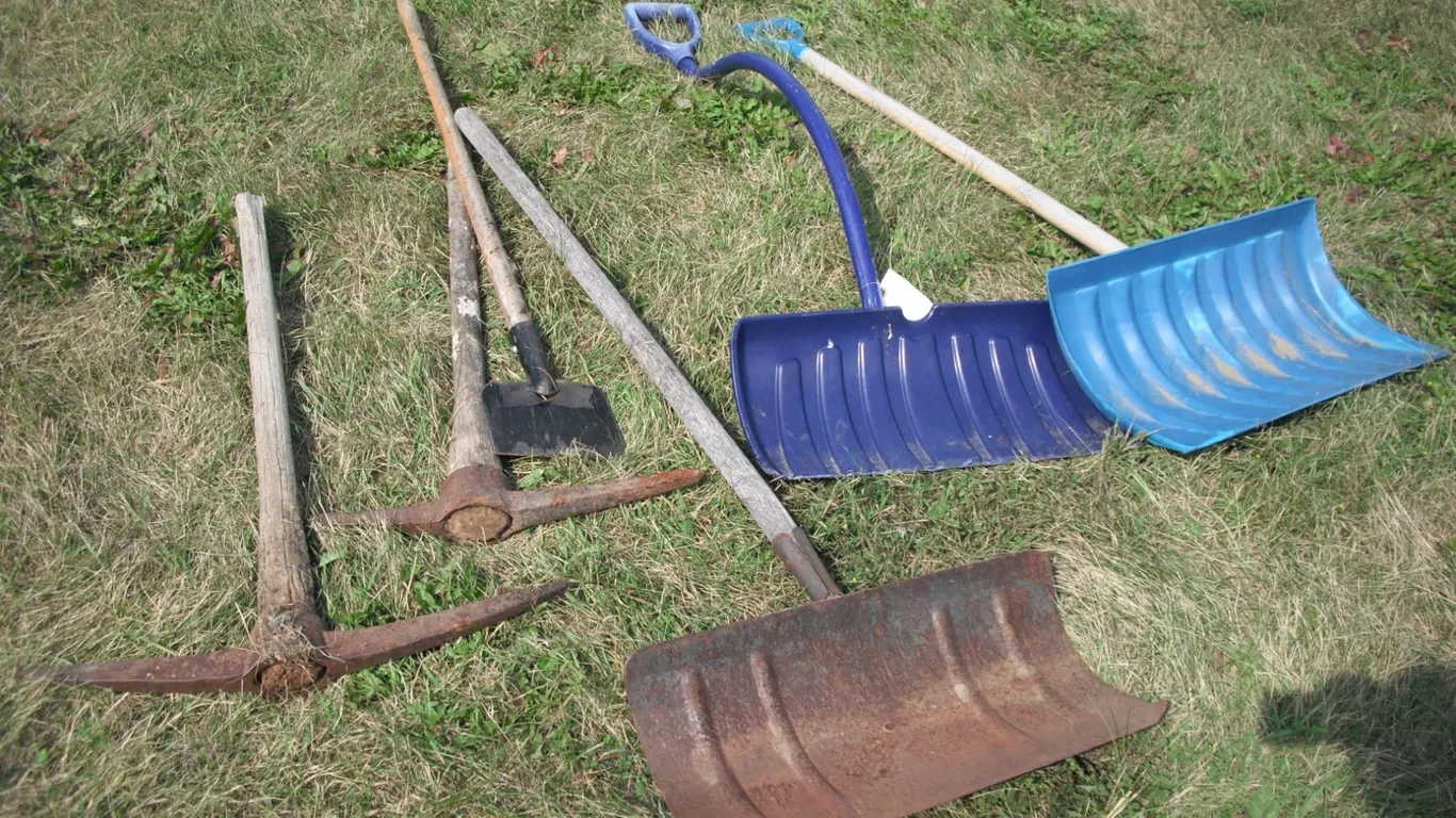lot of shovels, edger, pickaxes