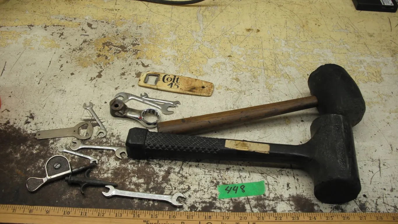 2 rubber mallets, assorted wrenches & tools, and colt 45 bottle opener