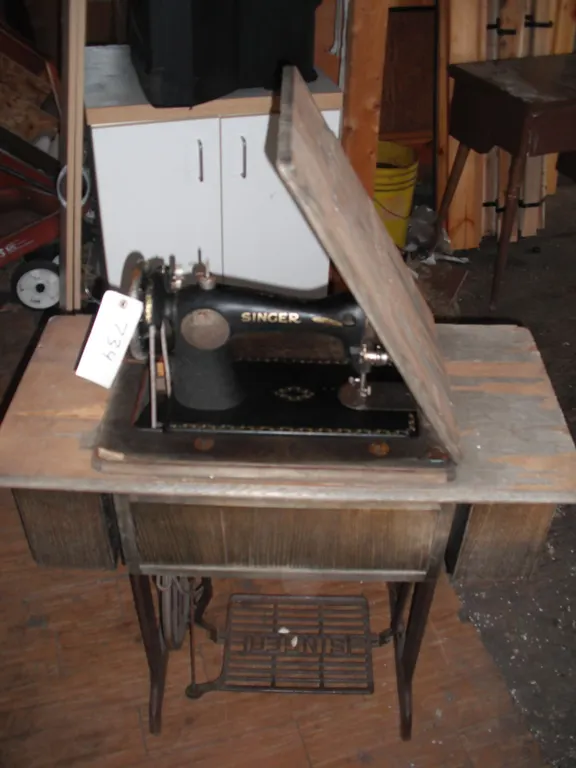 vintage singer sewing machine with cast iron base and accessories