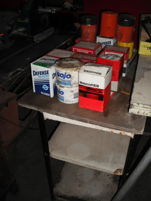 large lot of oil with work shelf/table