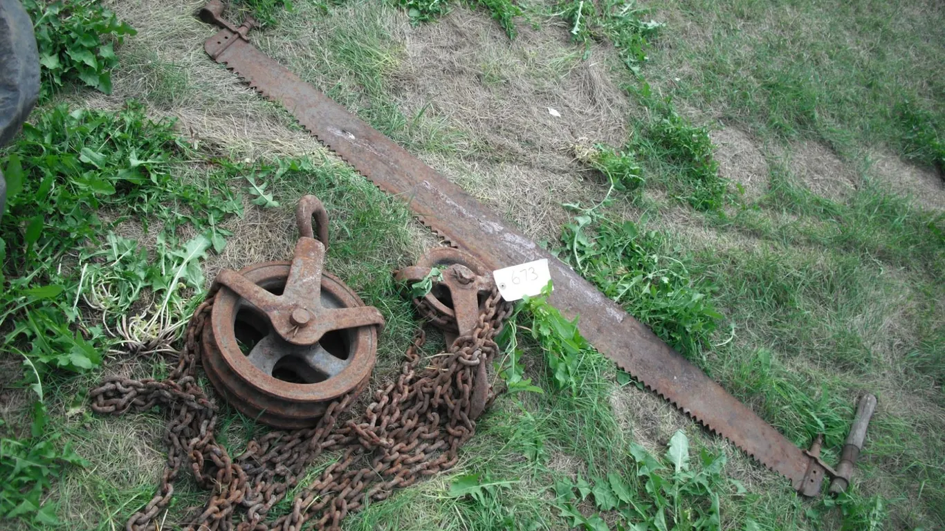 vintage steel pulley and crosscut saw