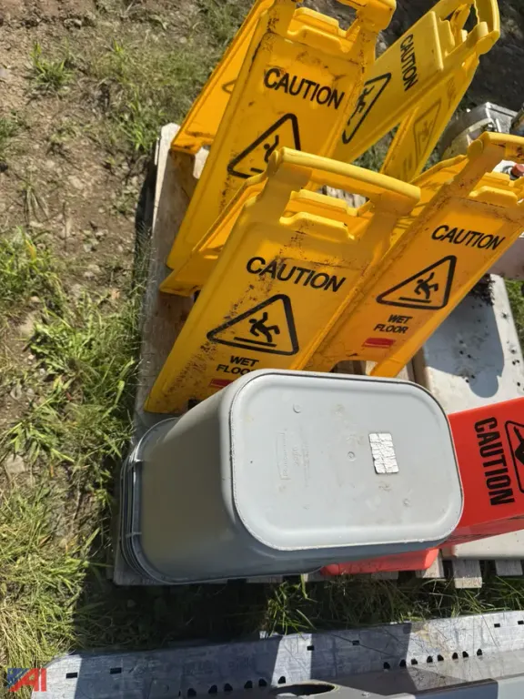 (4) Foldout Wet Floor Safety Signs and (7) Rubber Maid Garbage Cans