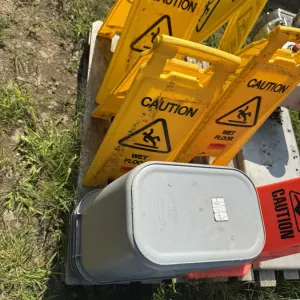 (4) Foldout Wet Floor Safety Signs and (7) Rubber Maid Garbage Cans