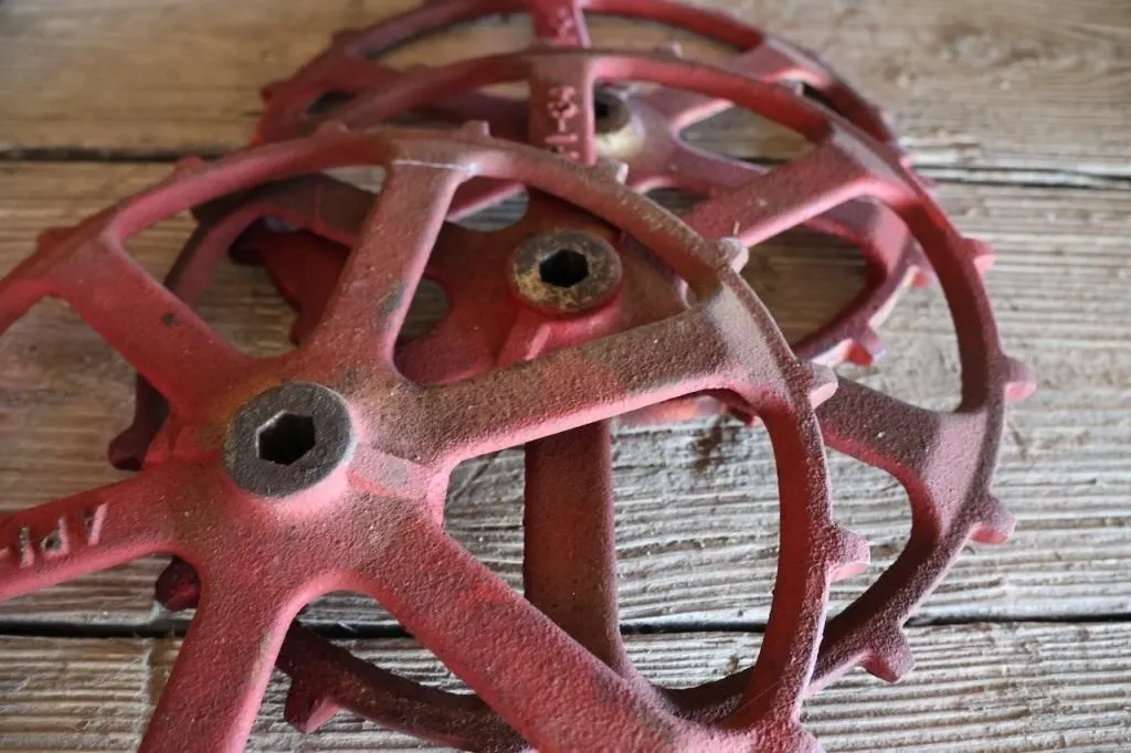 Three Crustbuster grain drill wheels and John