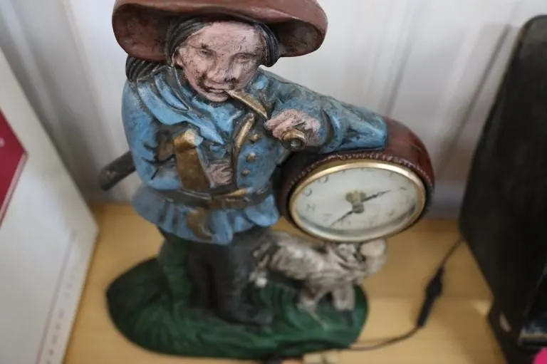 Cast iron statue with clock