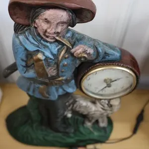 Cast iron statue with clock