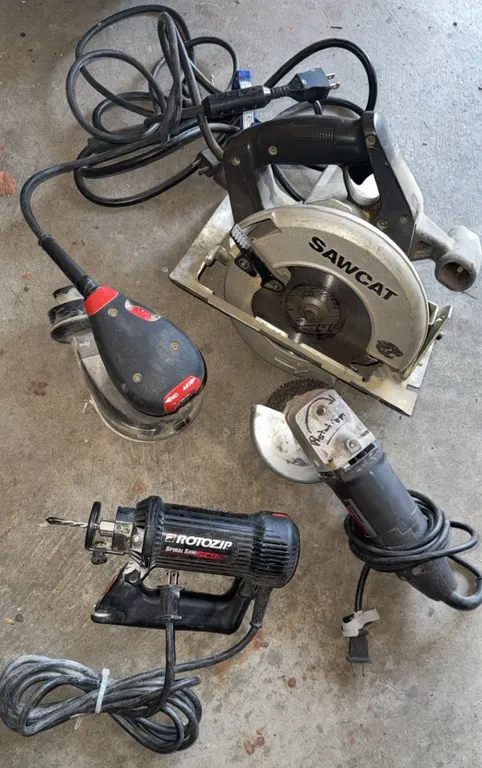 4 Power Tools Including RotoZip, Milwaukee Sander, Industrial Angle Grinder, and Sawcat Circular Saw