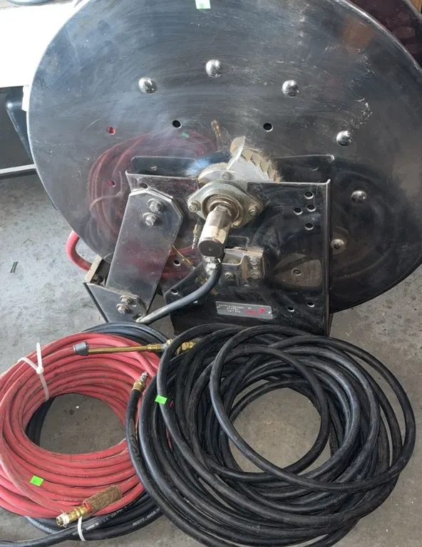 Industrial Metal Hose Reel With Red and Black Hoses