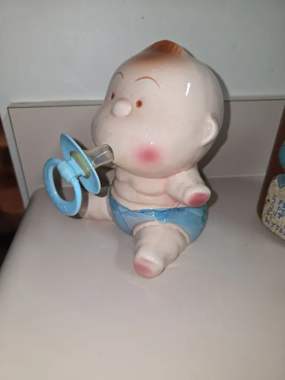 Vintage piggy bank, adorable baby and pacifier on small potty, ceramic, funny, children's room decor