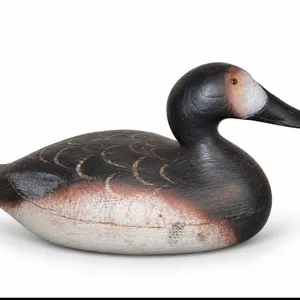 hand-carved wooden canvasback duck decoy, featuring painted feather details and a dark head