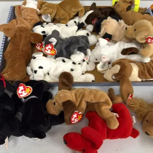 A Collection of Ty Original Beanie Babies Plush Dogs. (Ty, 1990s) An assortment of plush canine figures, including Spunky, Dotty, and others, featurin