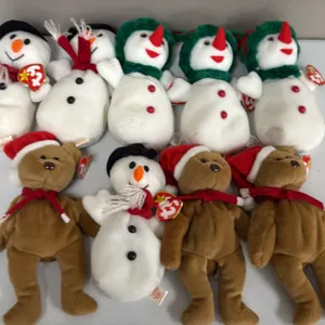 A Collection of Holiday Ty Beanie Babies. (Ty, 1997-2000) A group of 9 Ty Original Beanie Babies plush toys, including (3) 1997 Teddy bears with Santa