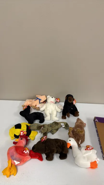 A Collection of Ty Original Beanie Babies. (Ty, 1990s) An assortment of (10) plush Beanie Babies including Strut the rooster, Halo the angel bear, Roa
