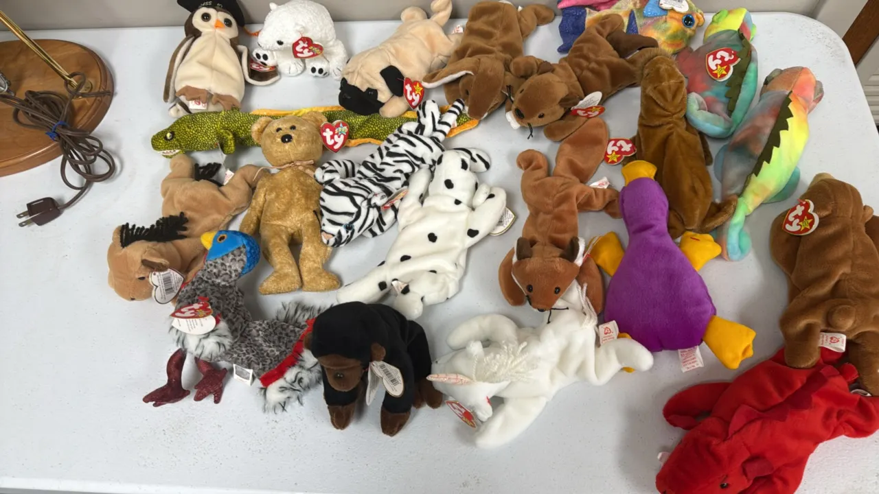 A Collection of Ty Original Beanie Babies. (Ty, 1990s) An assortment of plush Beanie Babies including Grunt the razorback, Wise the owl, Iggy, and oth