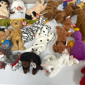A Collection of Ty Original Beanie Babies. (Ty, 1990s) An assortment of plush Beanie Babies including Grunt the razorback, Wise the owl, Iggy, and oth