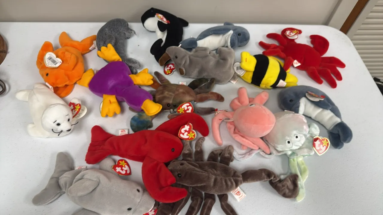 A Collection of Ty Beanie Babies. (Ty, 1990s) An assortment of 16 aquatic and marine-themed plush beanbag animals, including Goochy the jellyfish, Ink