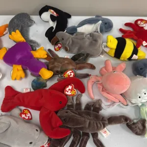 A Collection of Ty Beanie Babies. (Ty, 1990s) An assortment of 16 aquatic and marine-themed plush beanbag animals, including Goochy the jellyfish, Ink