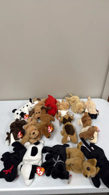 A Collection of Ty Original Beanie Babies Dogs. (Ty, 1990s) A collection of 16 Ty Beanie Babies plush dog figures, including Spot, Dotty, Wrinkles, an