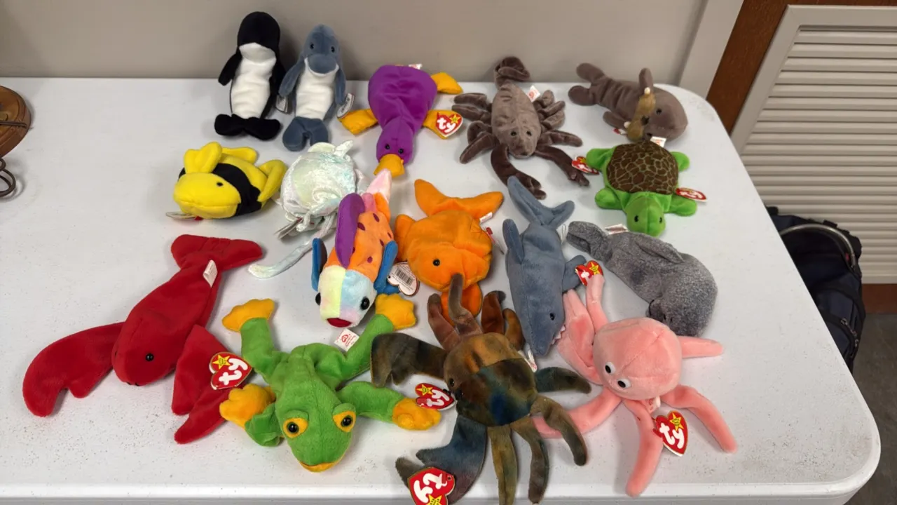 A Collection of Ty Beanie Babies. (Ty, 1990s) A collection of 16 assorted aquatic-themed plush figures including Pinchers the lobster, Claude the crab