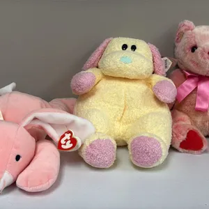 A Collection of Ty Plush Toys. (Ty, 1990s-2000s) A lot of three Ty plush toys including two Pillow Pals, "Carrots" the bunny and "Dogbaby" the dog, an
