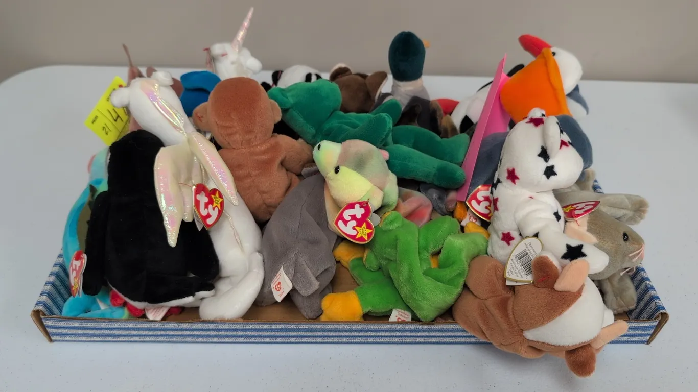 A Collection of Ty Original Beanie Babies Plush Toys. (Ty, 1990s) An assortment of 21 plush figures including Scat the cat, Erin the bear, Bongo the m