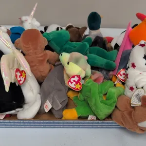 A Collection of Ty Original Beanie Babies Plush Toys. (Ty, 1990s) An assortment of 21 plush figures including Scat the cat, Erin the bear, Bongo the m