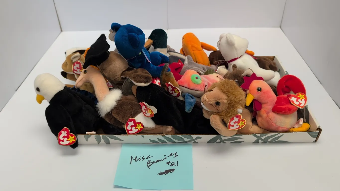 A Collection of Ty Beanie Babies. (Ty, 1990s) A collection of 21 assorted Ty Original Beanie Babies plush toys, including Iggy, Clubby, Claude, Batty,