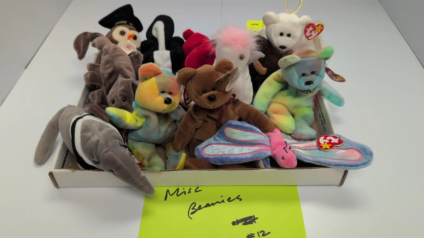 A Collection of Ty Beanie Babies. (Ty, 1990s) A collection of 12 original Beanie Babies plush toys, including Peace bear, Halo angel bear, Roam the bu
