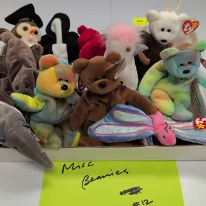 A Collection of Ty Beanie Babies. (Ty, 1990s) A collection of 12 original Beanie Babies plush toys, including Peace bear, Halo angel bear, Roam the bu