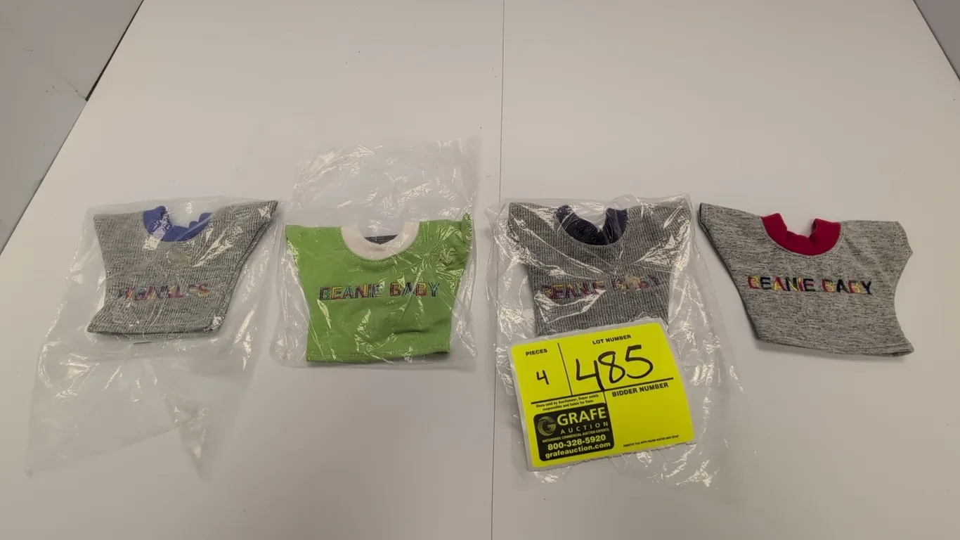 A Collection of Ty Original Beanie Babies T-Shirts. (Ty, 1990s) A set of four miniature plush t-shirts featuring embroidered lettering, including 'BEA