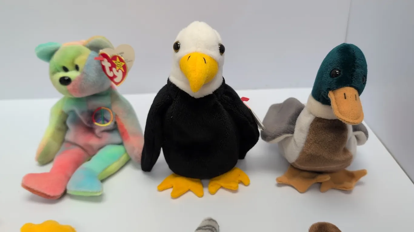 A Collection of Ty Original Beanie Babies. (Ty, 1990s-2000s) An assortment of plush Beanie Babies with attached Ty heart swing tags. Characters includ